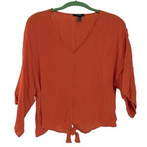 Forever 21 orange deep v blouse with tie bottom and buttons.  Small